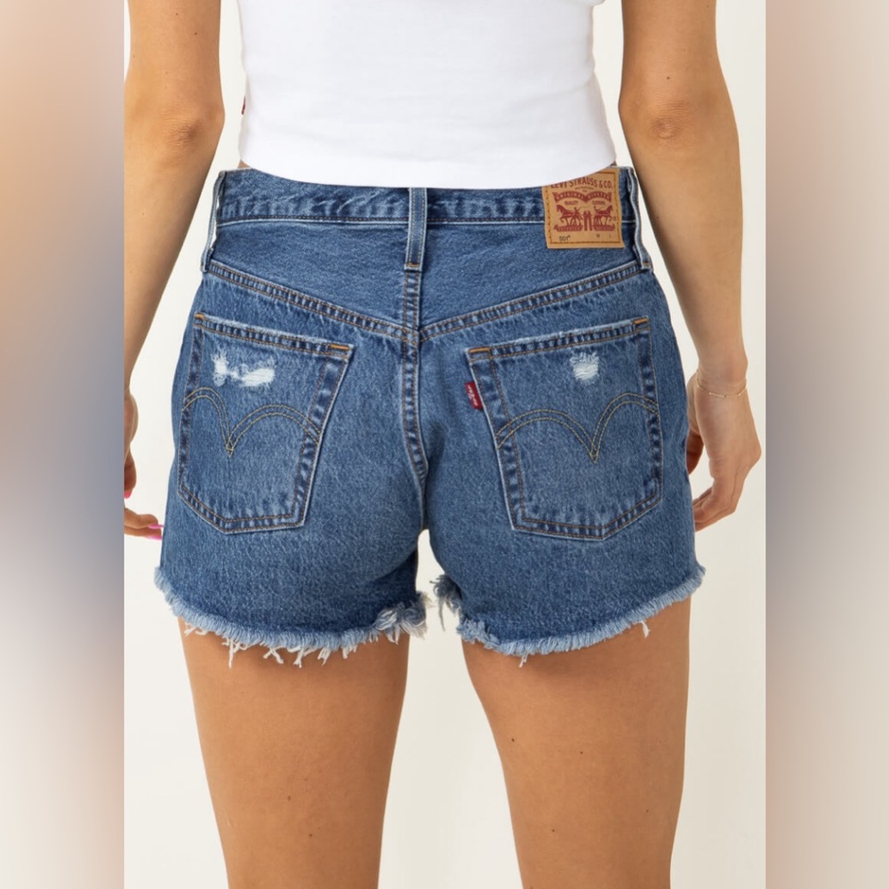 Levi’s 501 high waist lightly distressed medium wash jean shorts. Women size 28.